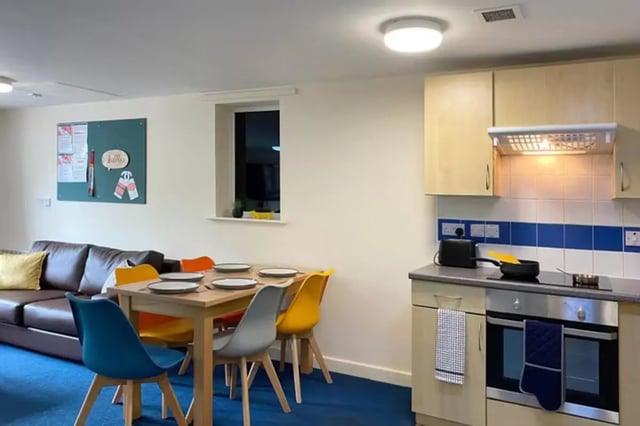 Brown sofa dining table chairs and kitchen living room at The Cube - Loughborough in Loughborough Student Accommodation