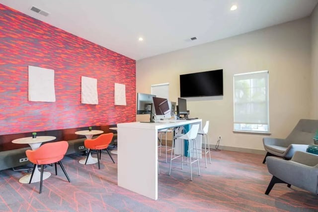 Computers, bar stools, and chairs study area at Orion on Orpington in Orlando Student Accommodation