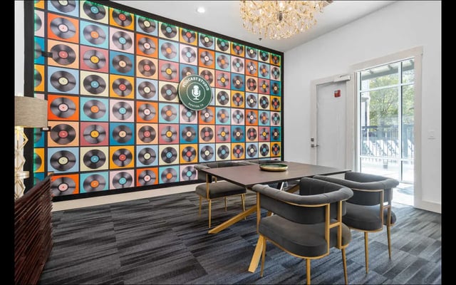 Vinyl record wall art with chairs and table study area at The Lorimer in Denton Student Accommodation
