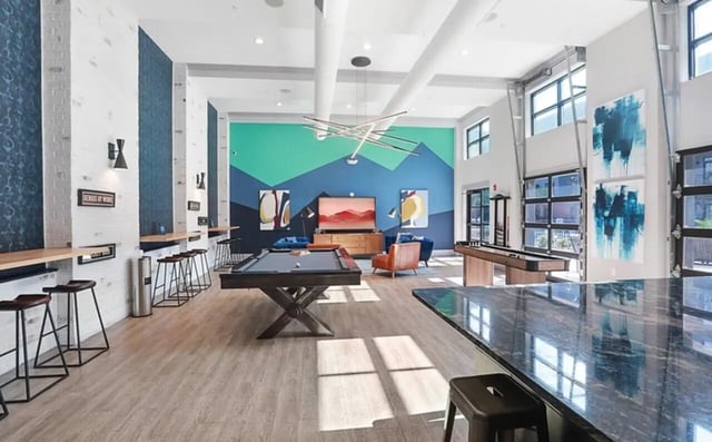 Pool table shuffleboard and seating area communal space at Greene Crossing Apartments in Columbia Student Accommodation