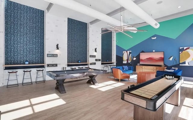 Pool table shuffleboard and seating living room at Greene Crossing Apartments in Columbia Student Accommodation