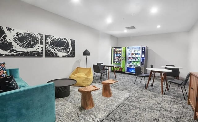 Sofa beanbag vending machines tables chairs communal area at Greene Crossing Apartments in Columbia Student Accommodation