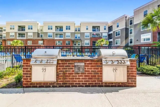 Two gas grills on brick base outdoor kitchen exterior at Quantum On West Call in Tallahassee Student Accommodation