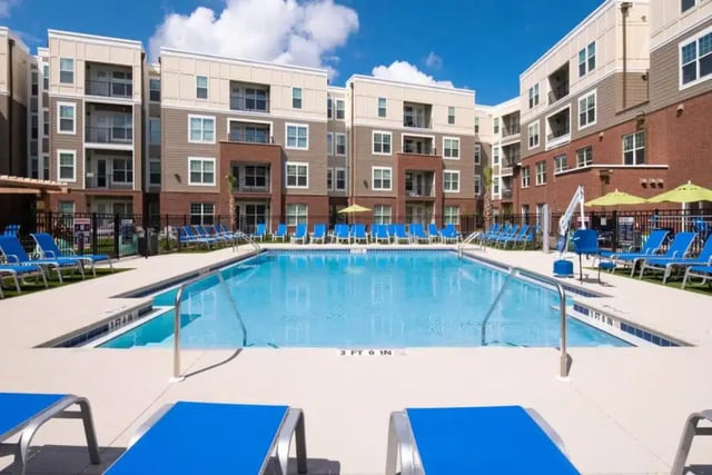 Swimming pool with lounge chairs exterior at Quantum On West Call in Tallahassee Student Accommodation