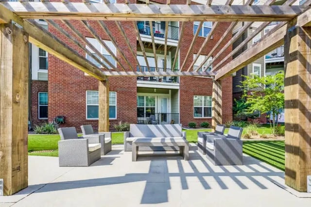 Outdoor seating area with sofas chairs table exterior at Quantum On West Call in Tallahassee Student Accommodation