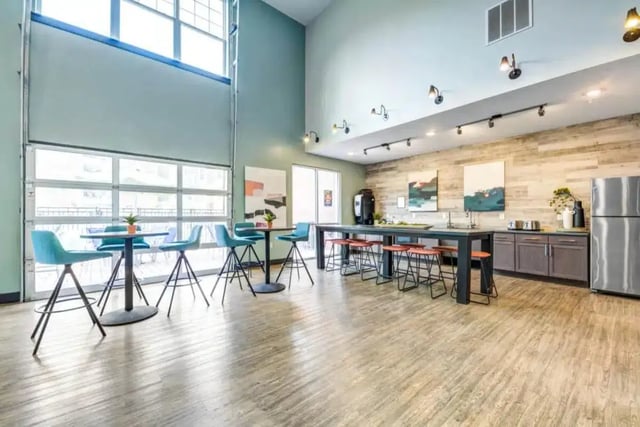 High tables with blue stools kitchen area at Quantum On West Call in Tallahassee Student Accommodation