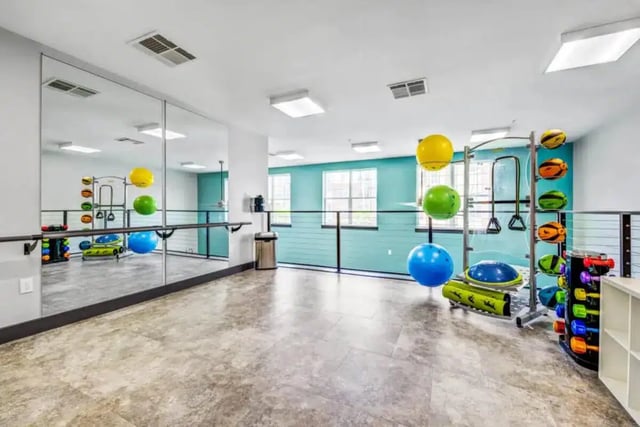 Mirrored wall exercise equipment exercise balls gym at Quantum On West Call in Tallahassee Student Accommodation