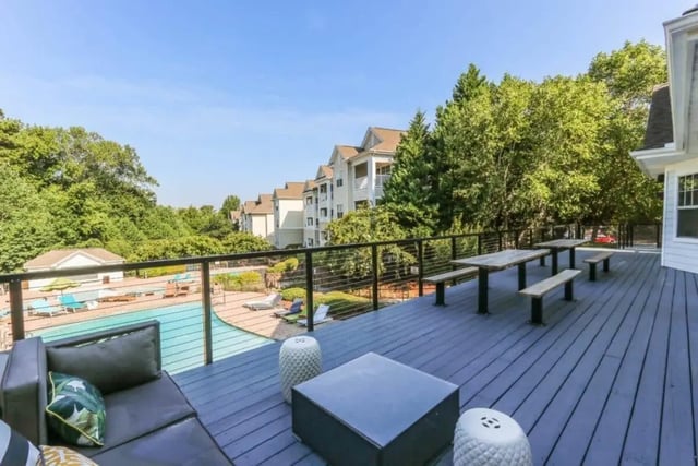Deck with seating picnic tables and pool view exterior at Campus Edge Apartments in Raleigh Student Accommodation