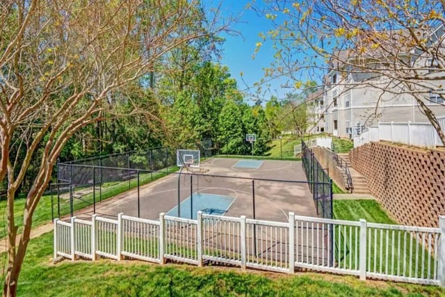 Basketball court with fencing and buildings exterior at Campus Edge Apartments in Raleigh Student Accommodation