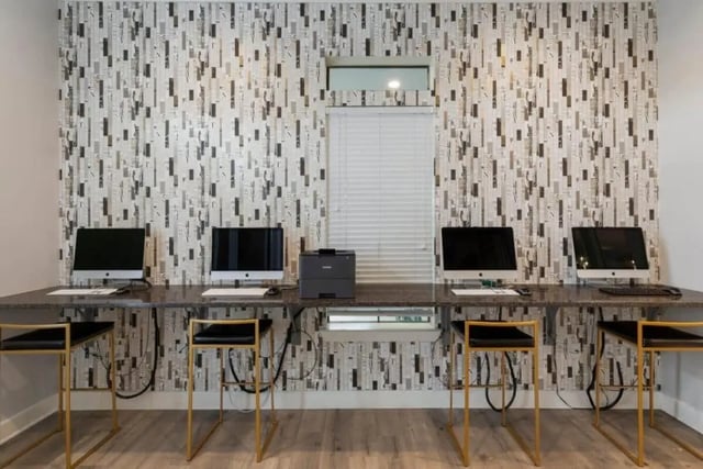 Computers and stools at long desk study area at Arba in San Marcos Student Accommodation
