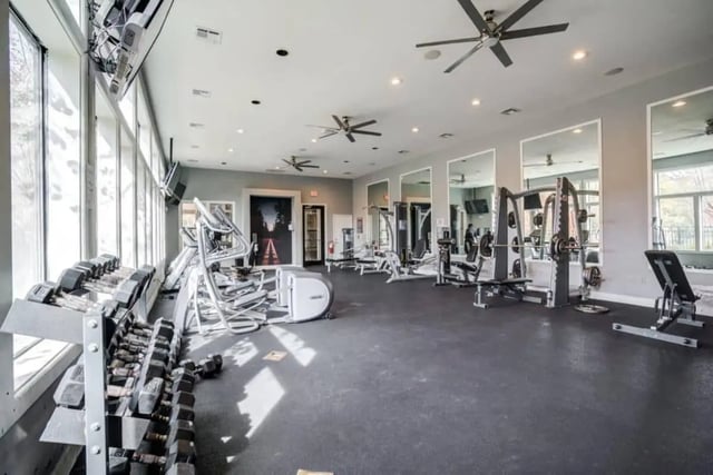 Dumbbells treadmills weight machines gym area at The Mill at Auburn in Auburn Student Accommodation