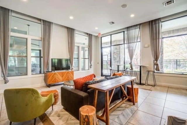 Sofa TV console wood table stools living room at The Mill at Auburn in Auburn Student Accommodation