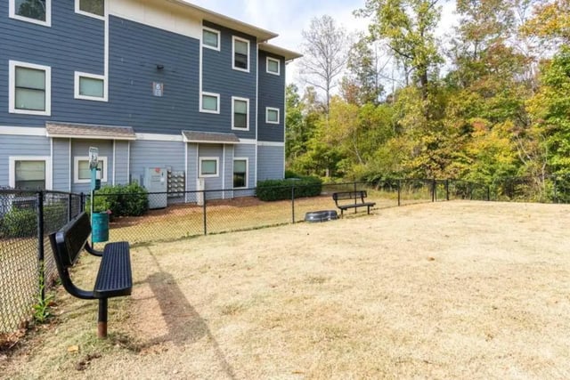 Fenced dog park area with benches exterior at The Mill at Auburn in Auburn Student Accommodation