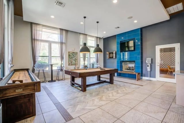 Shuffleboard pool table fireplace playing area at The Mill at Auburn in Auburn Student Accommodation