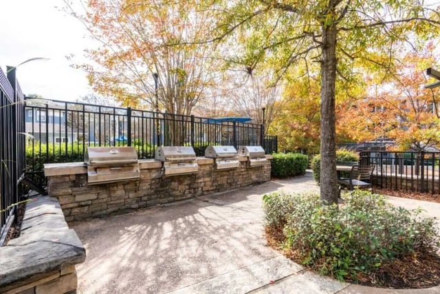 Four built in grills on stone counter outdoor area at The Mill at Auburn in Auburn Student Accommodation