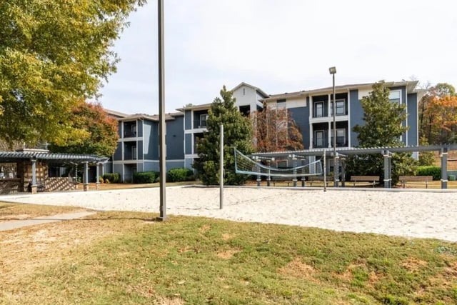 Volleyball court with apartments and picnic shelter exterior at The Mill at Auburn in Auburn Student Accommodation