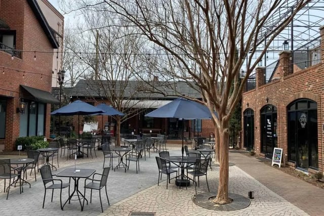 Tables chairs umbrellas outdoor patio exterior at Courtyard Lofts in Chapel Hill Student Accommodation