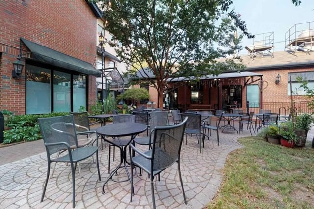 Outdoor seating with tables and chairs patio area at Courtyard Lofts in Chapel Hill Student Accommodation