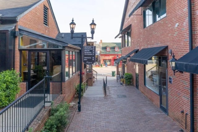 Brick buildings with awnings and streetlights exterior at Courtyard Lofts in Chapel Hill Student Accommodation