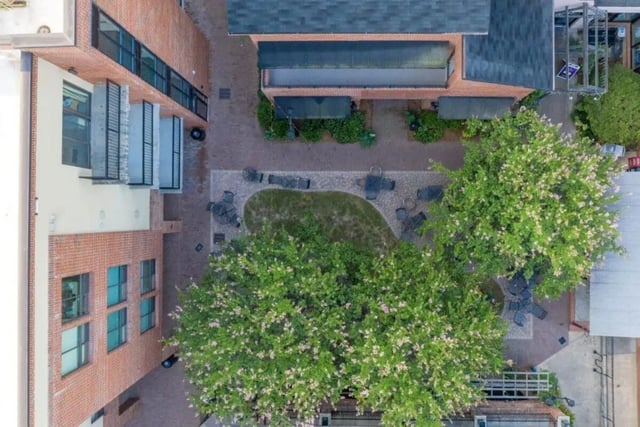 Courtyard with trees tables and seating exterior at Courtyard Lofts in Chapel Hill Student Accommodation