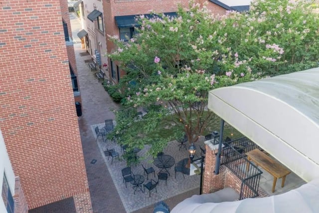Outdoor seating area with tables and chairs exterior at Courtyard Lofts in Chapel Hill Student Accommodation