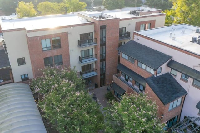 Apartment building with balconies and trees exterior at Courtyard Lofts in Chapel Hill Student Accommodation