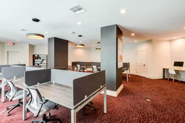 Desks with chairs and computer stations study area at The Nest At University Center in Rock Hill Student Accommodation