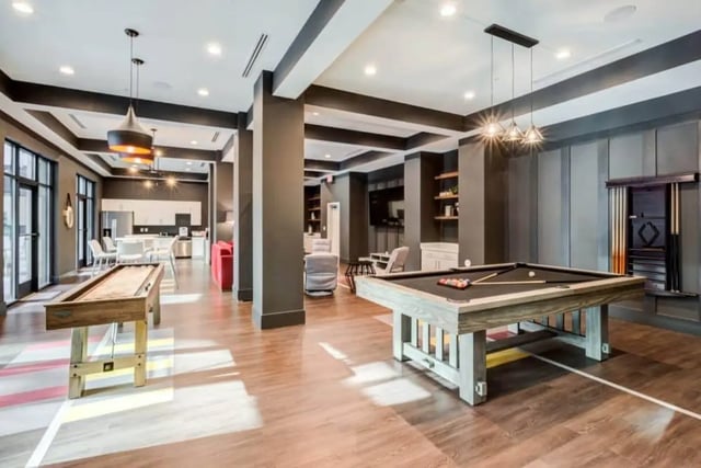 Pool table shuffleboard kitchen lounge area at The Nest At University Center in Rock Hill Student Accommodation