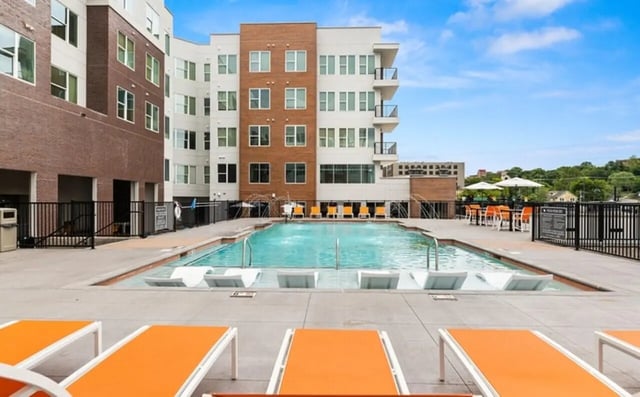 Modern apartment building with pool and lounge chairs Exterior at Nova Knoxville in Knoxville Student Accommodation