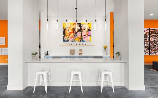 Counter with stools artwork and plants lobby at Nova Knoxville in Knoxville Student Accommodation