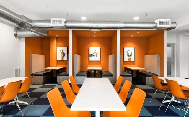 Orange booths and tables with art study area at Nova Knoxville in Knoxville Student Accommodation