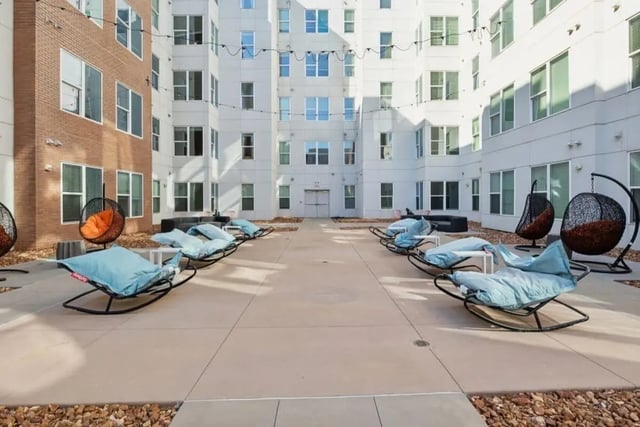 Rocking lounge chairs and hanging chairs courtyard exterior at Nova Knoxville in Knoxville Student Accommodation