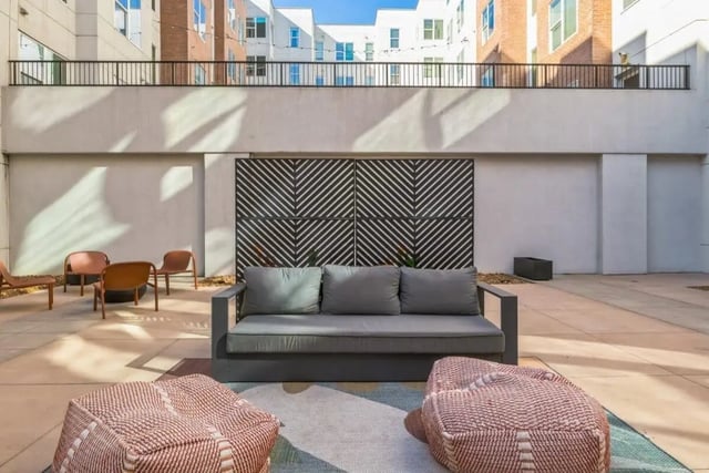 Gray sofa ottoman chairs patterned wall exterior at Nova Knoxville in Knoxville Student Accommodation