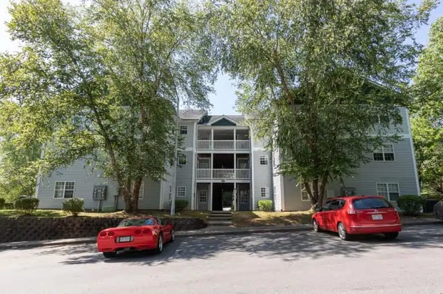 Apartment building with balconies cars exterior at University Woods in Raleigh Student Accommodation