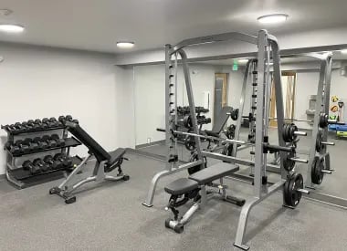 Weights bench power rack gym equipment fitness area at University Glen in Raleigh Student Accommodation