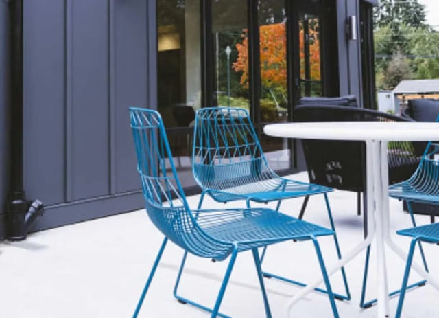 Blue chairs and white table exterior playing area at University Glen in Raleigh Student Accommodation
