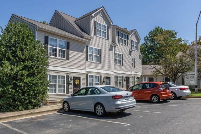 Townhouses with cars and trees exterior at Red Wolf Crossing in Raleigh Student Accommodation
