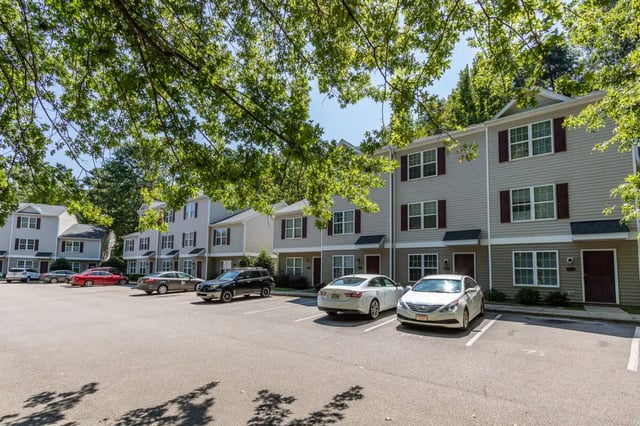 Apartments with cars parked exterior at Red Wolf Crossing in Raleigh Student Accommodation
