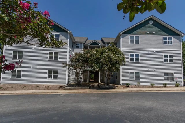 Apartment building with many windows exterior at Red Wolf Crossing in Raleigh Student Accommodation