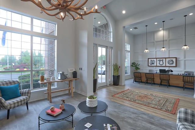 Chandelier coffee tables chairs and reception desk living room at The Bryn in State College Student Accommodation