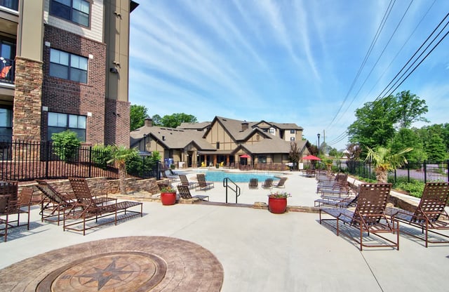 Pool lounge chairs and building exterior. Pool area. at University Village at 2505 in Raleigh Student Accommodation