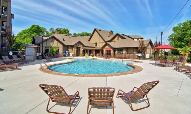Pool lounge chairs and a swimming pool exterior at University Village at 2505 in Raleigh Student Accommodation