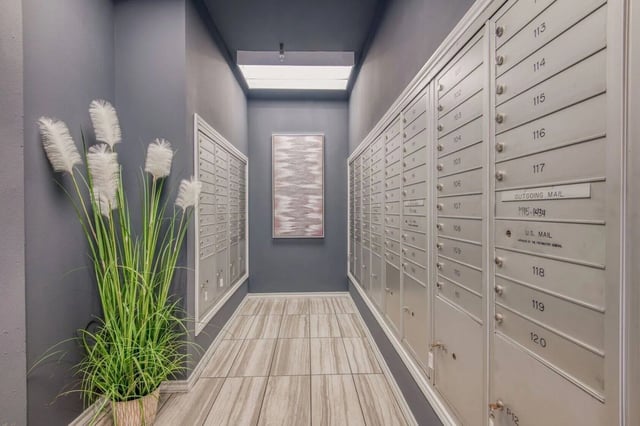 Mailboxes and tall plant hallway exterior at Cherry Street in College Station Student Accommodation