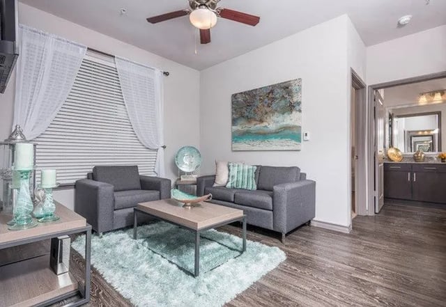 Two gray couches coffee table shag rug living room at Cherry Street in College Station Student Accommodation