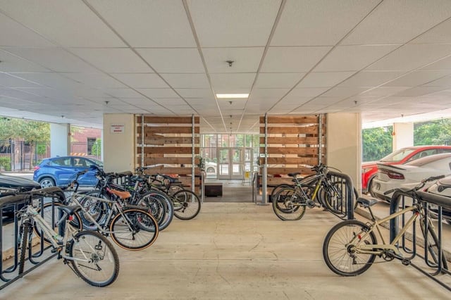 Bicycles and cars in covered parking area exterior at Cherry Street in College Station Student Accommodation