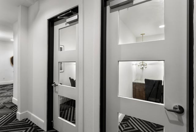 Doors with glass panels showing office spaces interior at Berkeley House in College Station Student Accommodation
