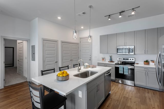 Island sink with lemons chairs appliances kitchen at Berkeley House in College Station Student Accommodation