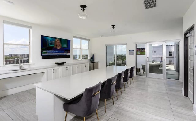 Modern lounge area with long table and chairs living room at The Hudson Northgate in College Station Student Accommodation