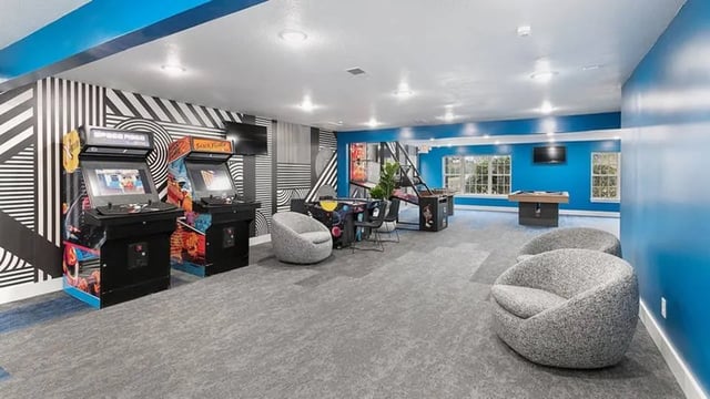 Arcade games lounge chairs table game game room at The Hangout in Starkville Student Accommodation