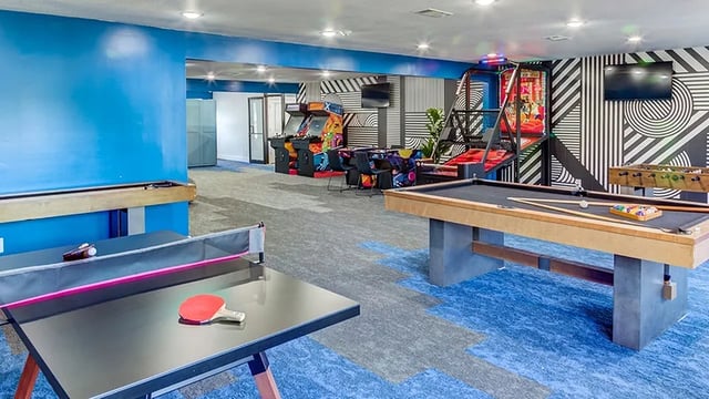 Game room with pool table arcade games and ping pong table recreation area at The Hangout in Starkville Student Accommodation